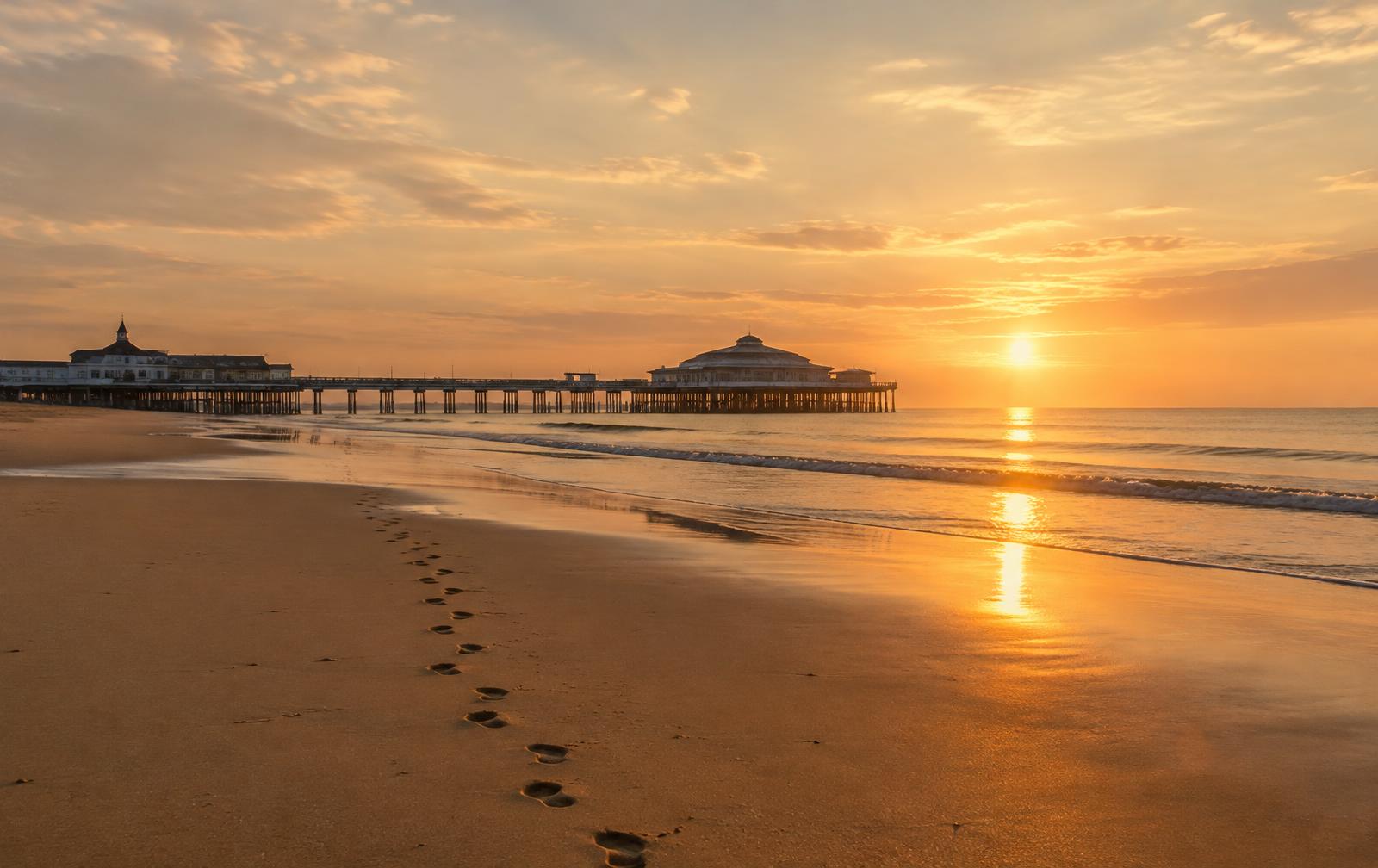 Footprints on Southport beach at sunrise